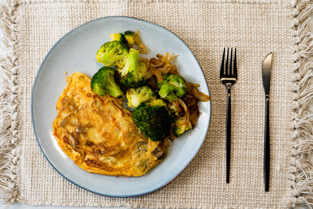 Tortilla de champiñones con guarnición de brócoli y cebolla pochada